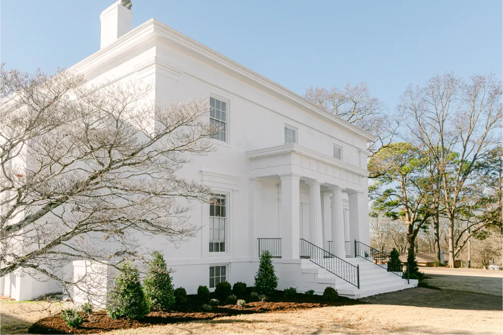 The Venue at Oak Place historic exterior with grand columns and oak trees